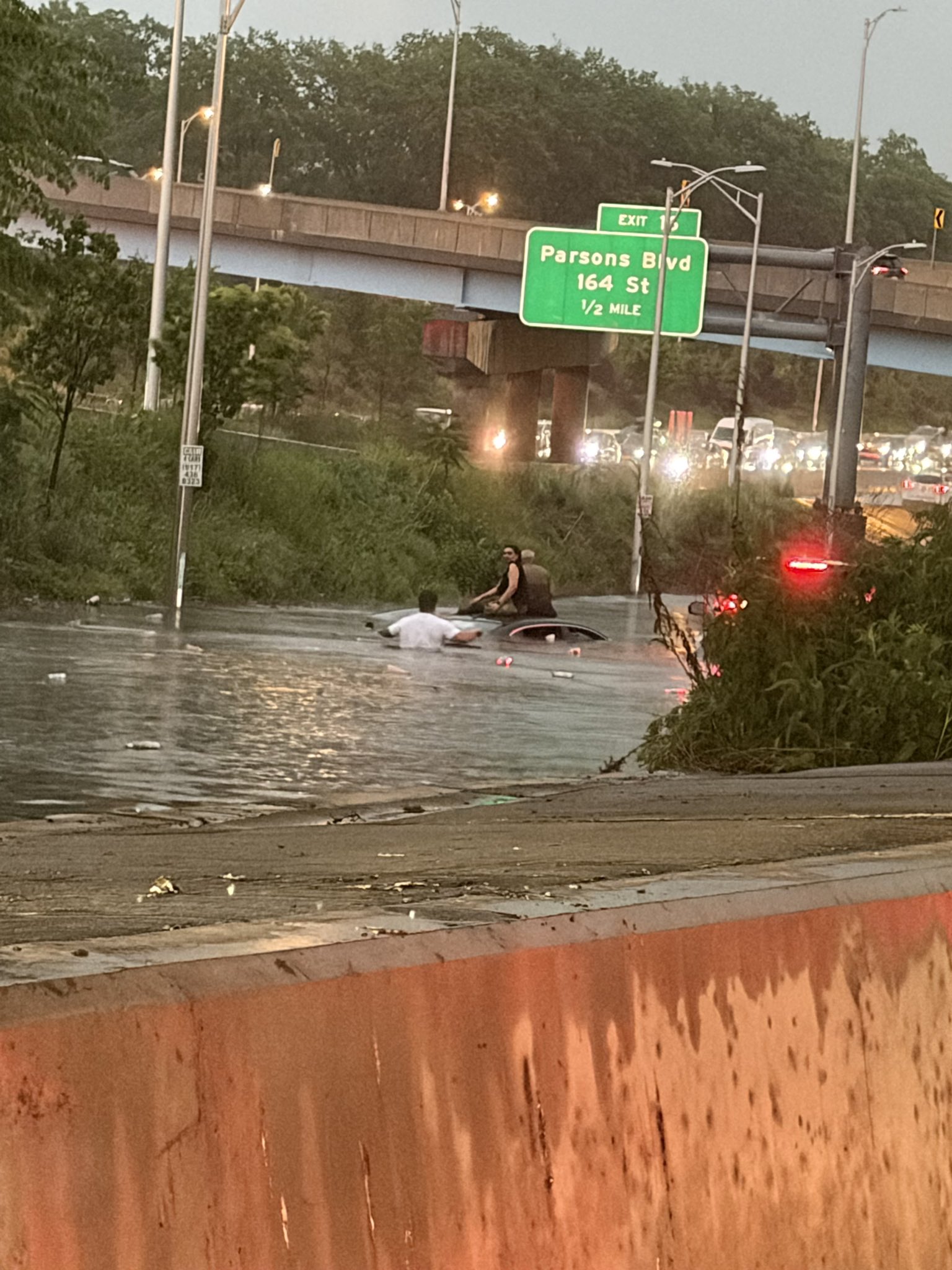 VIDEO: Car Submerged on Jackie Robinson Parkway — Good Samaritan Rescues Trapped Occupants as NYC Roads Become Impassable
